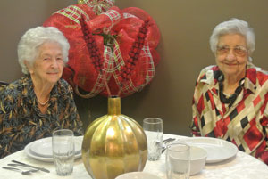 two elderly woman enjoying dinner together