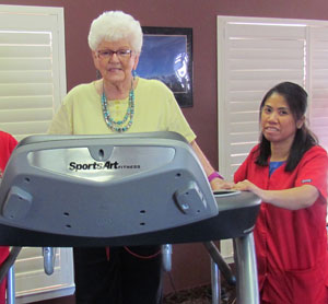 nurse helping patient exercise on treadmill